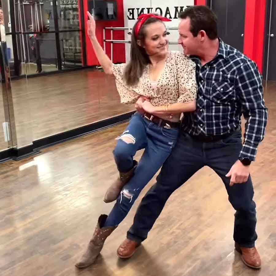 Couple doing a country swing dance lean move