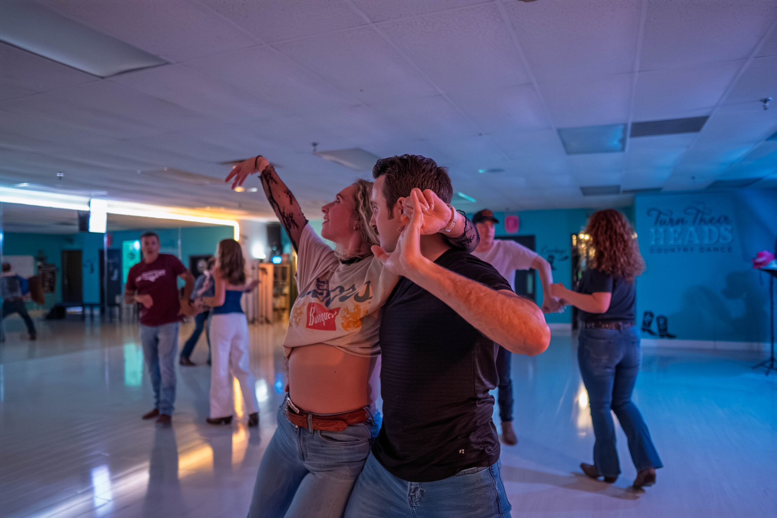 Couple doing a country swing dance lean move